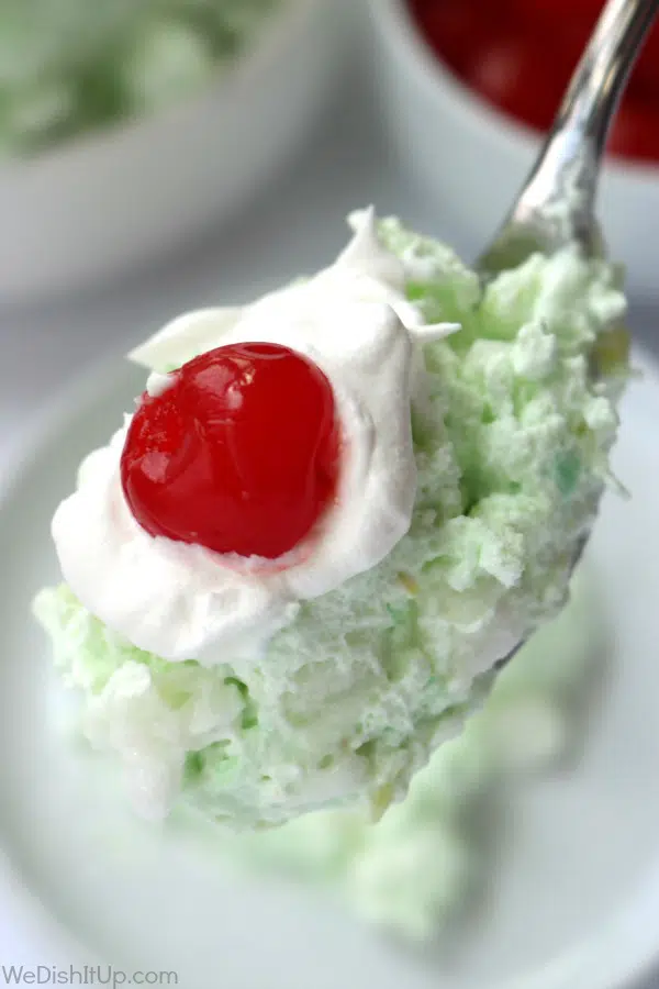 Fluffy Watergate Salad with cherry on spoon