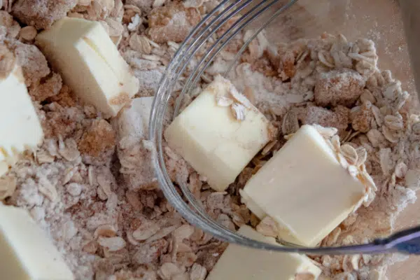 Cutting butter into oat topping 